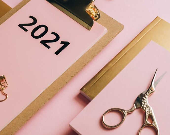 composition of office supplies on pink background