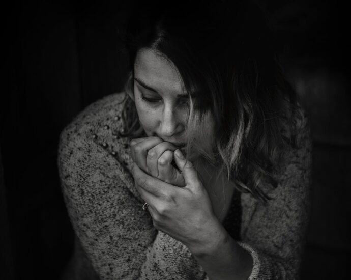 greyscale photography of woman wearing long sleeved top