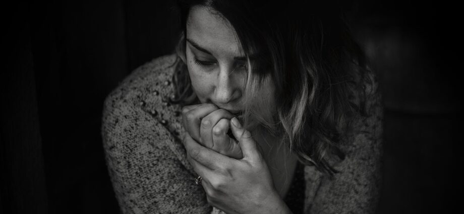 greyscale photography of woman wearing long sleeved top