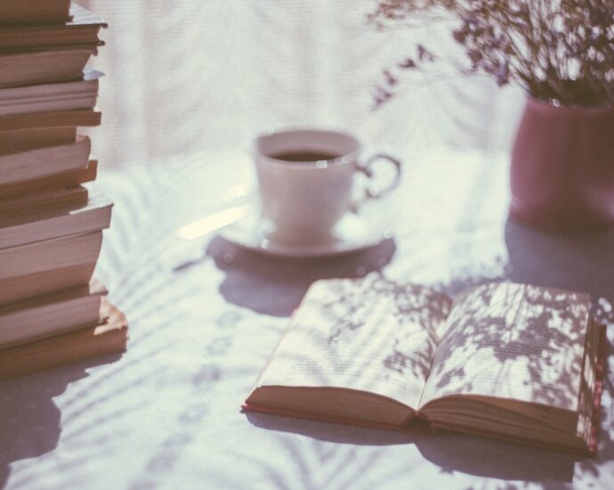 opened book near ceramic mug