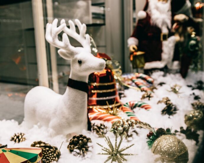 shop showcase festive decorations with shiny baubles and santa figurine