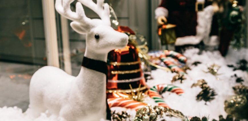 shop showcase festive decorations with shiny baubles and santa figurine