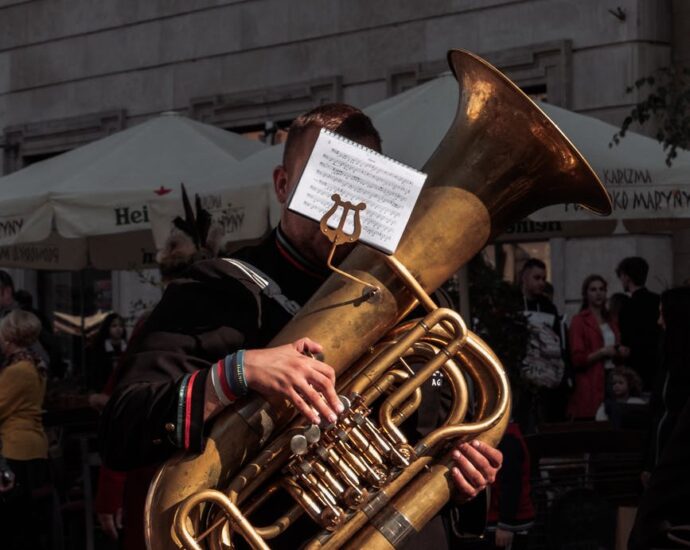man playing a brown wind musical instrument