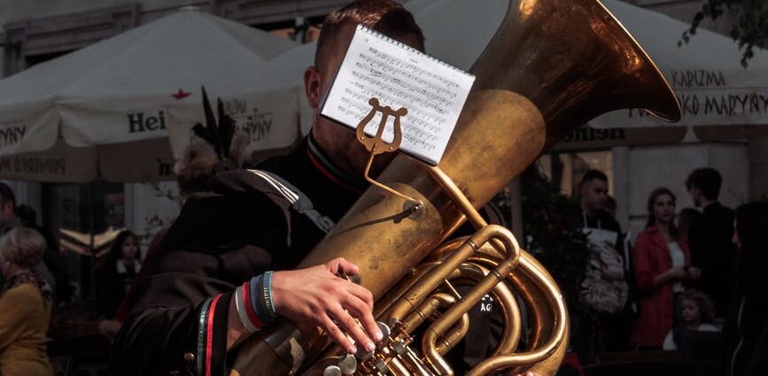 man playing a brown wind musical instrument